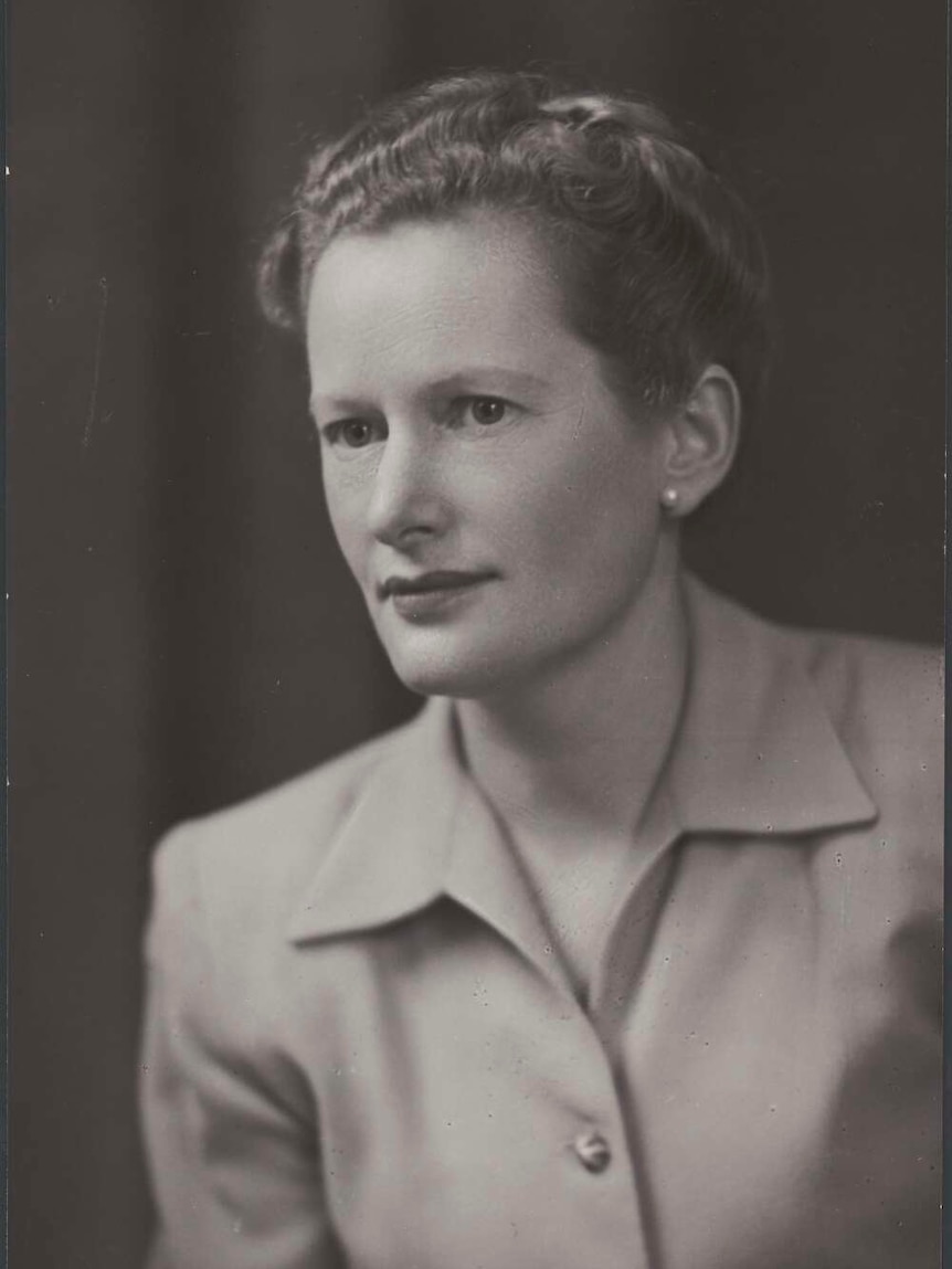 A black-and-white portrait of a young woman in a blouse.