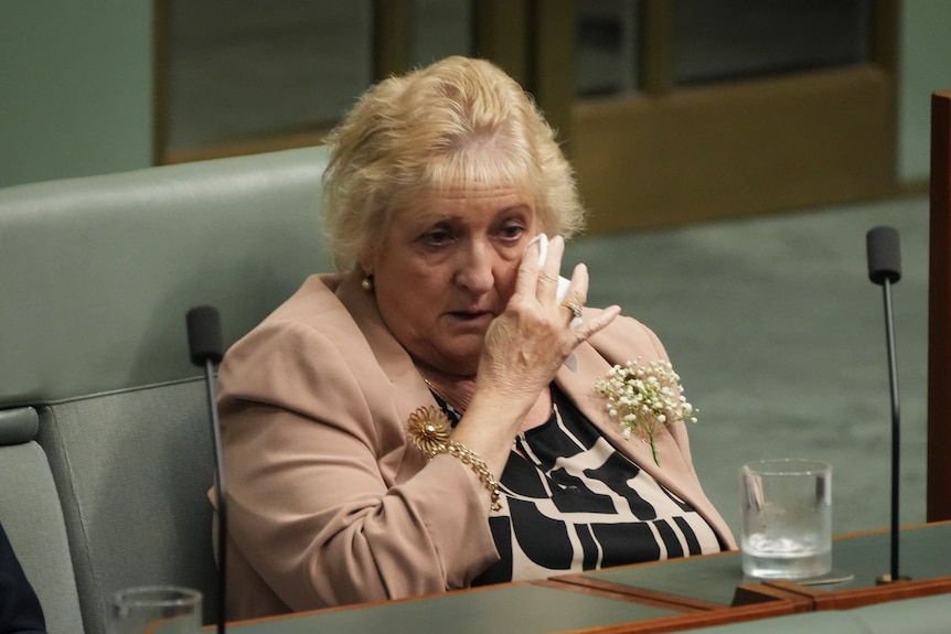 Michelle Landry, member for Capricornia, wipes tears. 