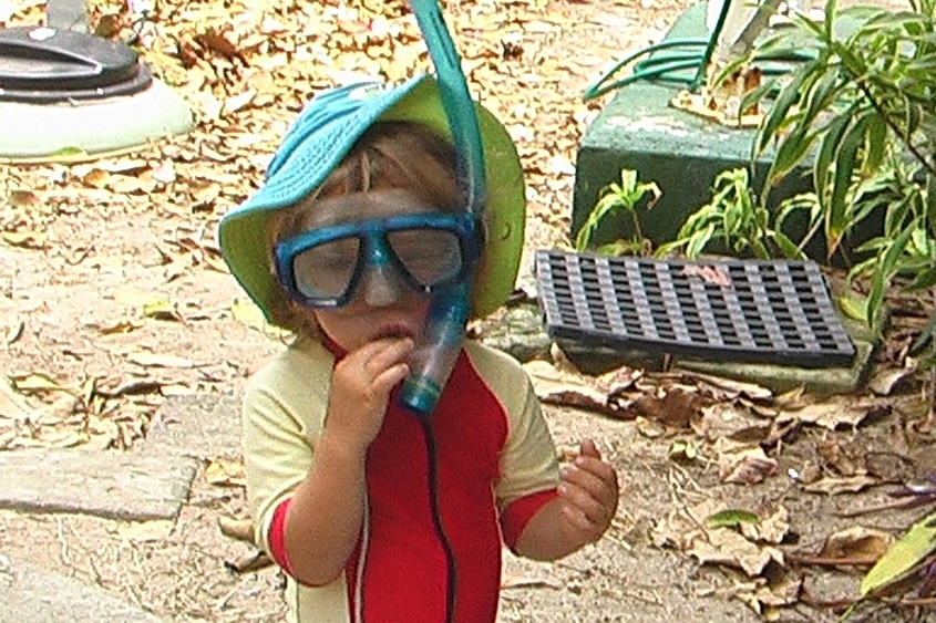 A toddler wearing snorkelling gear