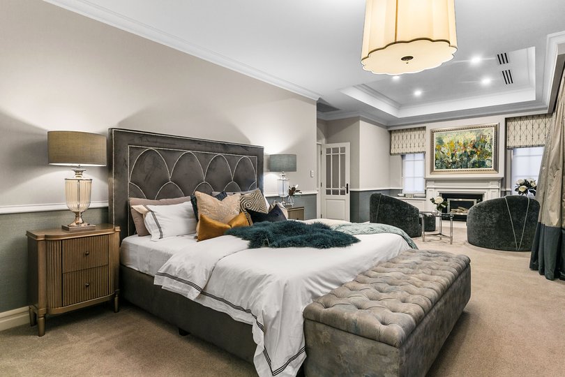 A palatial haven, the master suite boasts a fireplace, a makeup station, an enormous dressing room and a lavish ensuite.