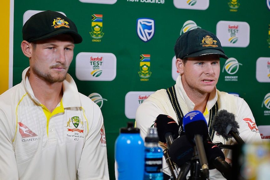 Cameron Bancroft and Steve Smith sit at a press conference