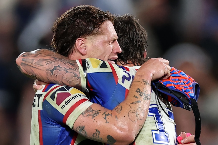 Kalyn Ponga cries as he hugs Dylan Lucas after beating Penrith in their NRL preliminary final.