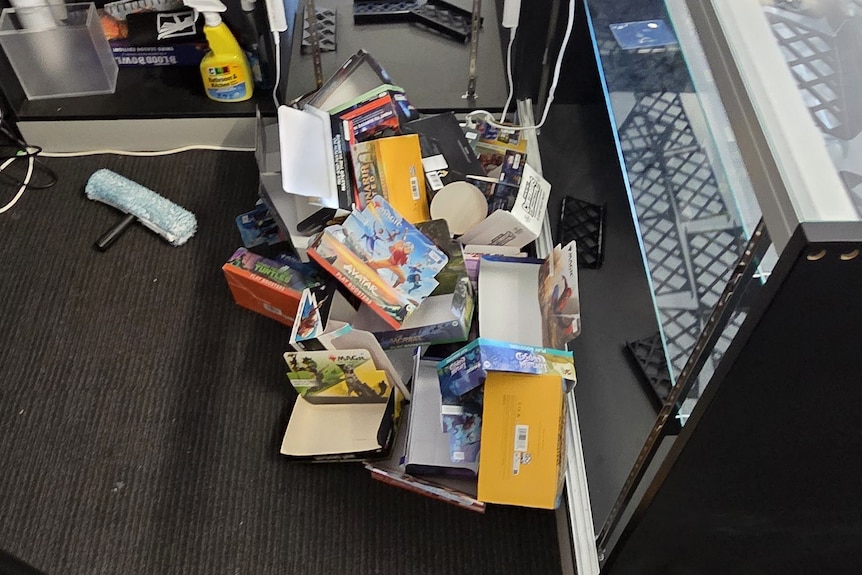 Empty boxes of popular video game merchandise in a pile next to a glass cabinet