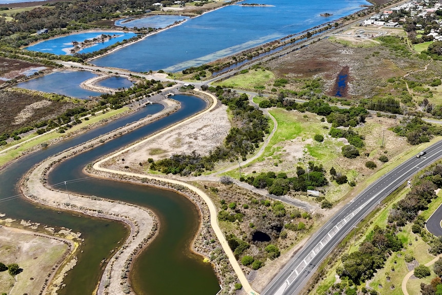 A drone shot of a block in Point Lonsdale bordered by canals and the Bellarine Highway