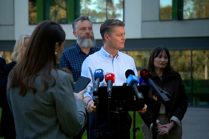 Ben Carroll addresses the media with wife Fiona by his side.