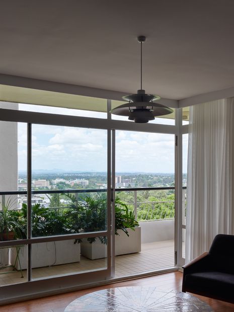 The replanned apartment opens living spaces to a generous balcony and city views.