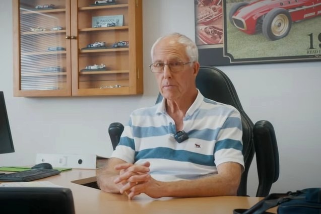 Steve Budden sits at a desk in an office.