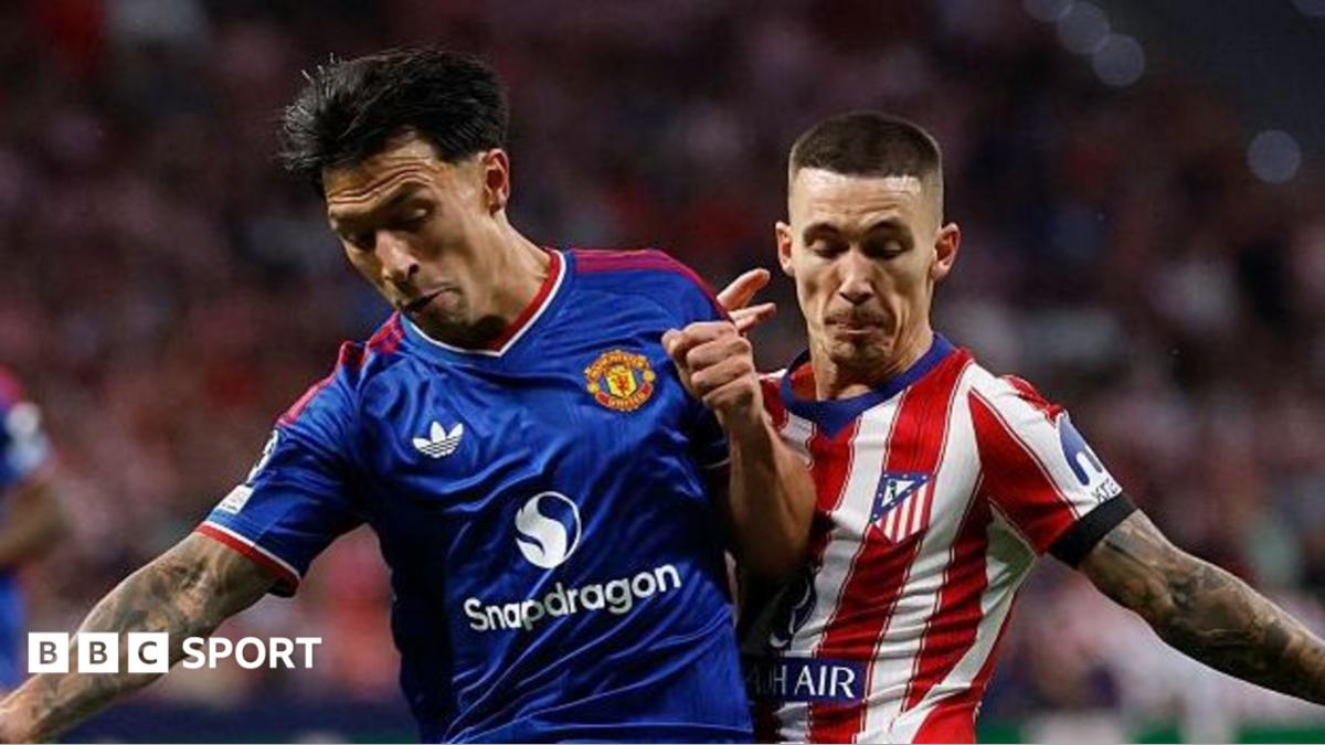 Lisandro Martinez, wearing Manchester United's blue away kit, battles for possession against Atletico Madrid