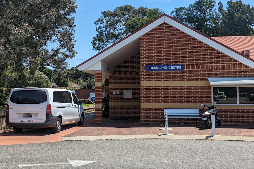 The brick exterior of the Frankland Centre with a van labelled "security" parked outside