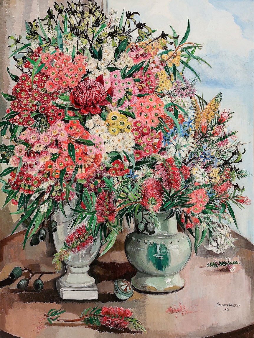 Painting of a vase bursting with Australian flowers including bottlebrush and gum blossoms in red and pink