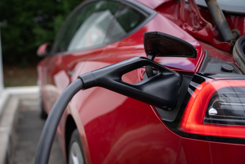 A close up of a charging plug in an electric car.