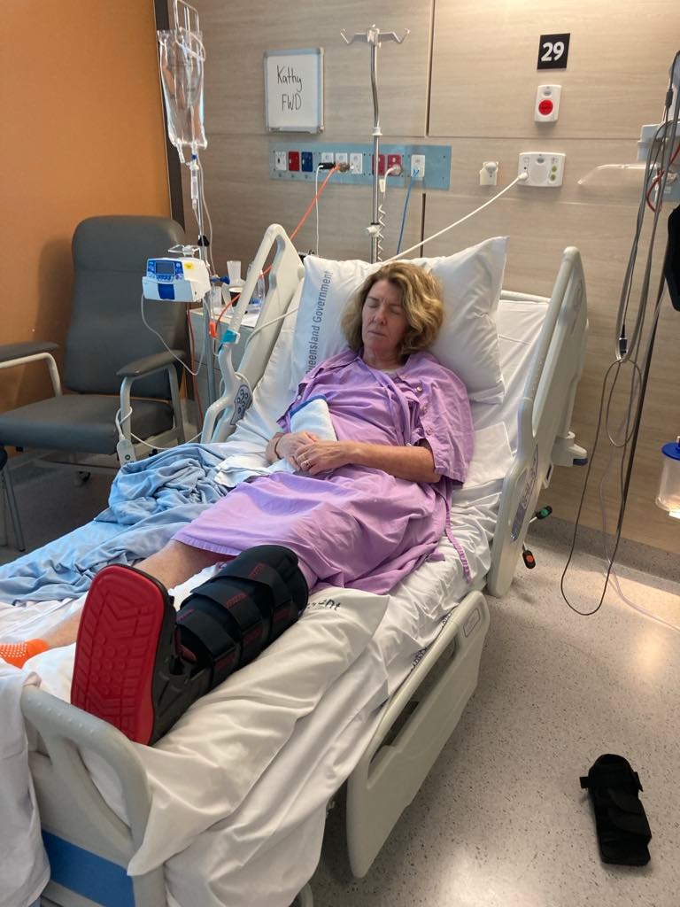 Woman in hospital bed with leg in cast