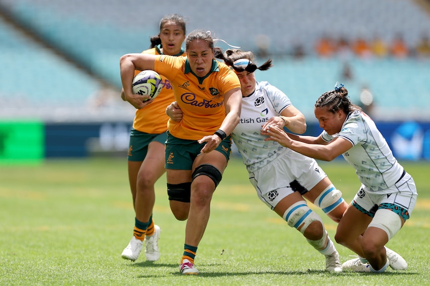 Siokapesi Palu Sekona makes a run with the ball for the Wallaroos against Scotland.