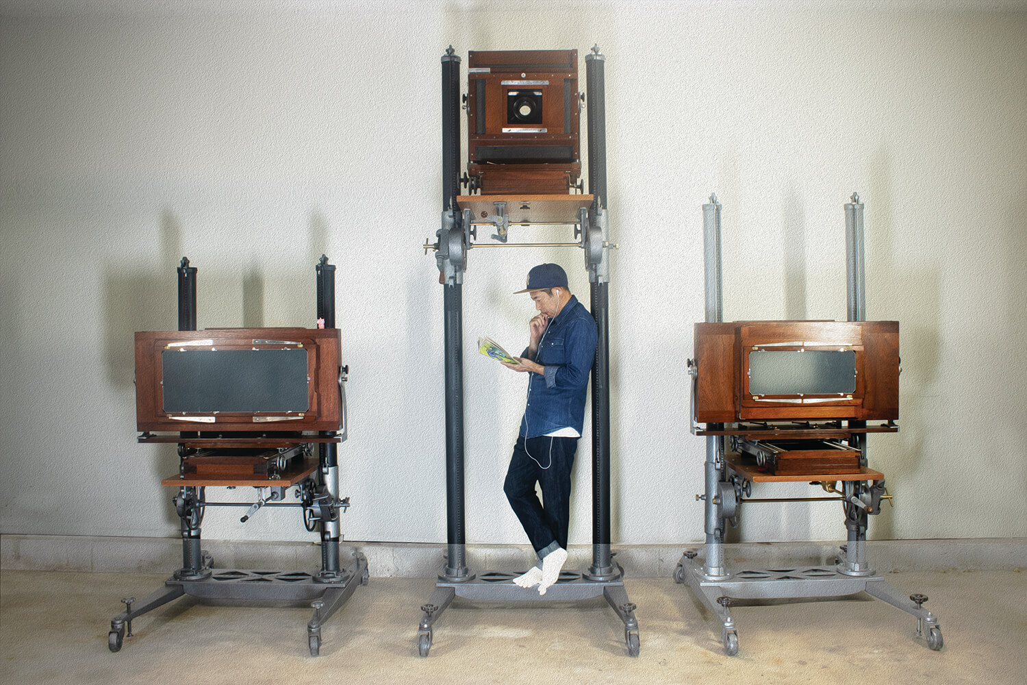 Man standing in front of antique cameras.