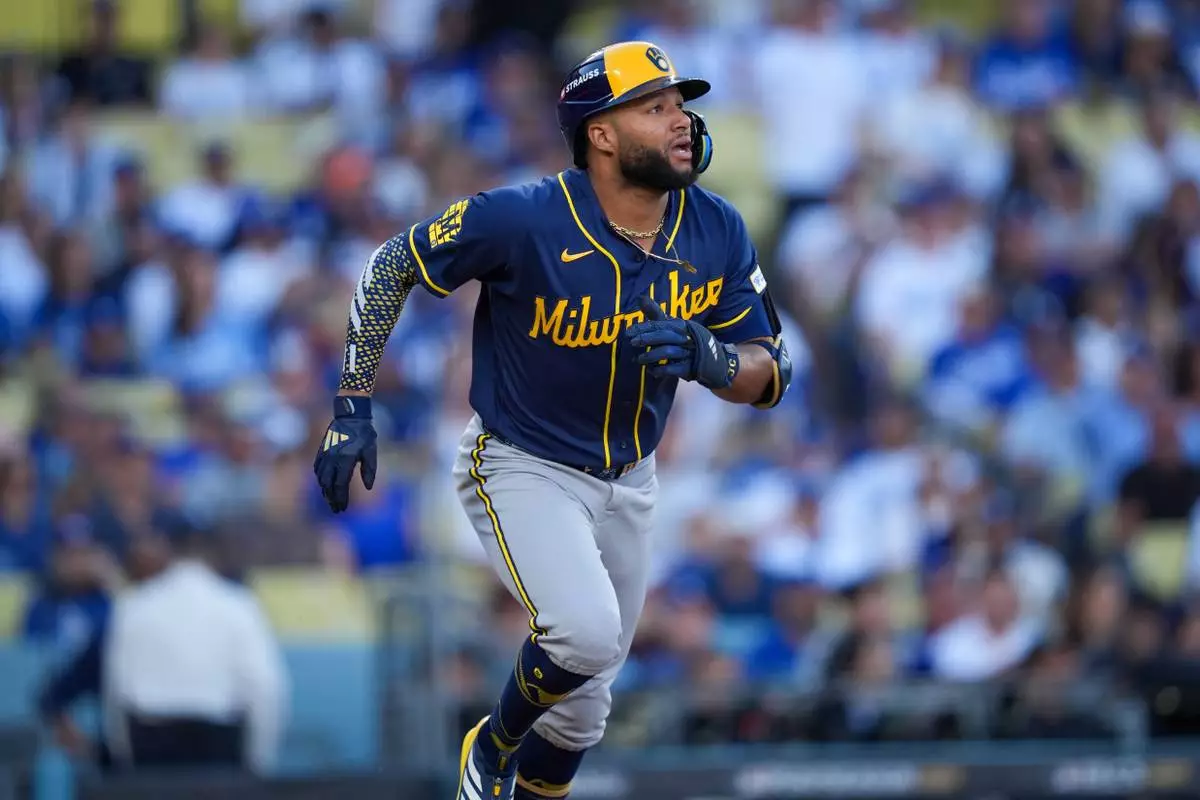 Milwaukee Brewers left fielder Jackson Chourio watches his solo home run take flight during the first inning of Game 3 of baseball's National League Championship Series between the Milwaukee Brewers and the Los Angeles Dodgers, Wednesday, Oct. 14, 2026, in Los Angeles. (AP Photo/Gregory Bull)