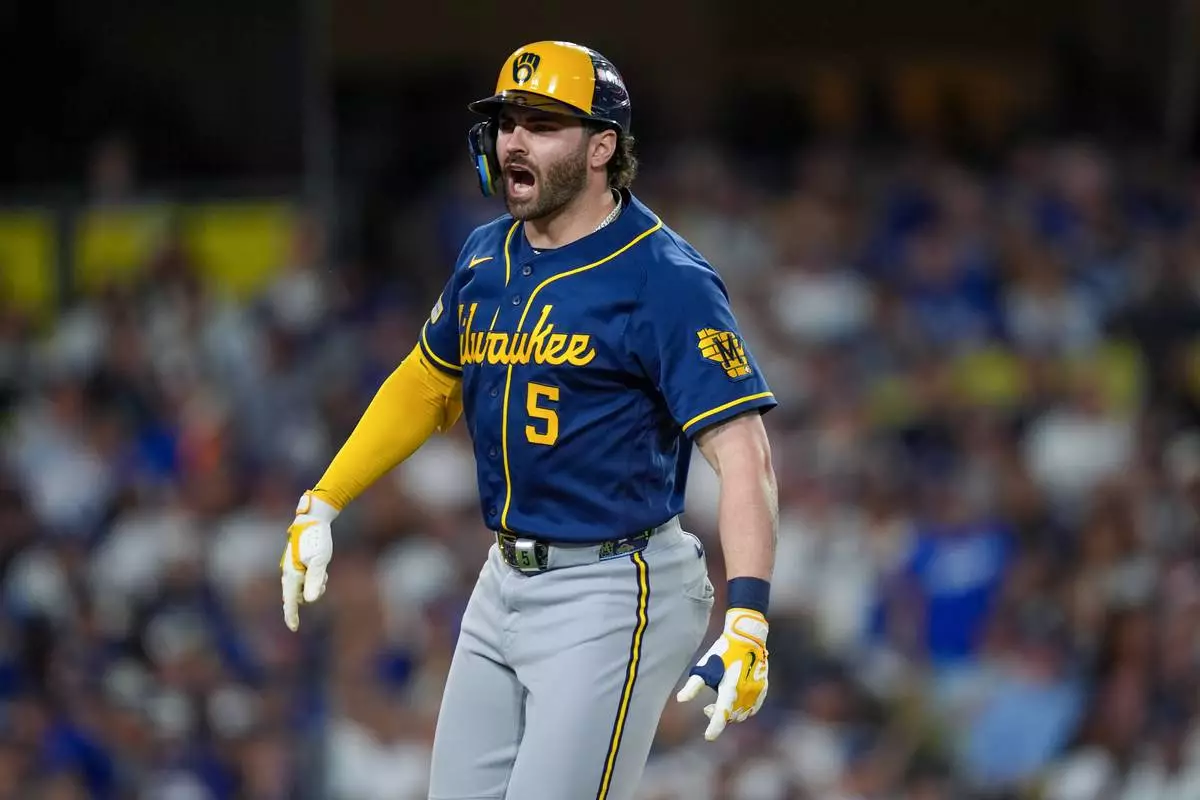 Milwaukee Brewers center fielder Garrett Mitchell yells towards his dugout after hitting a solo home run during the seventh inning of Game 3 of baseball's National League Championship Series between the Milwaukee Brewers and the Los Angeles Dodgers, Wednesday, Oct. 14, 2026, in Los Angeles. (AP Photo/Gregory Bull)