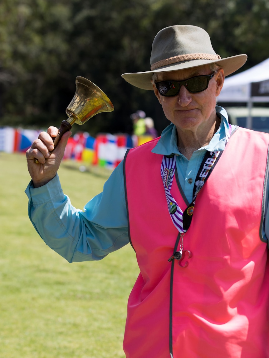 Man holding gold bell 