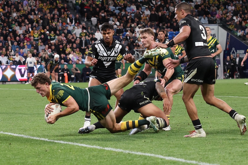 A man reaches out to score a try in a Test match