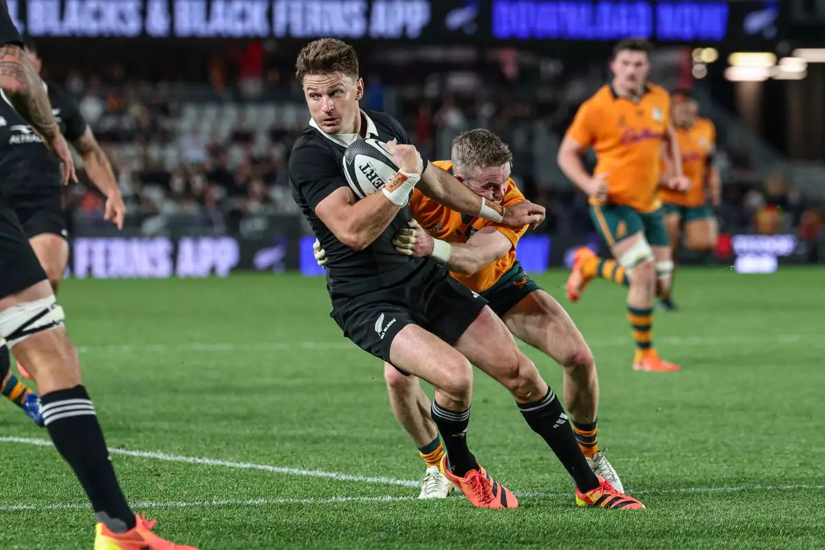 New Zealand's Beauden Barrett, left, is tackled by Australia's Ryan Lonergan during a Bledisloe Cup rugby union test match in Auckland, New Zealand on Saturday, Oct. 10, 2026. (Shane Wenzlick/Photosport via AP)