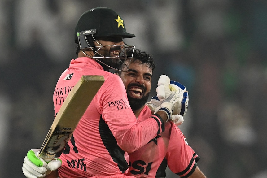 Haris Rauf and Shadab Khan hug in celebration on the pitch