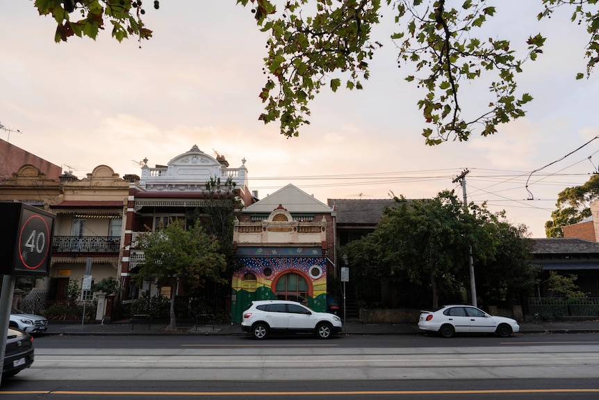 A building with a rainbow facade at dusk