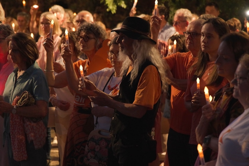 People holding candles.