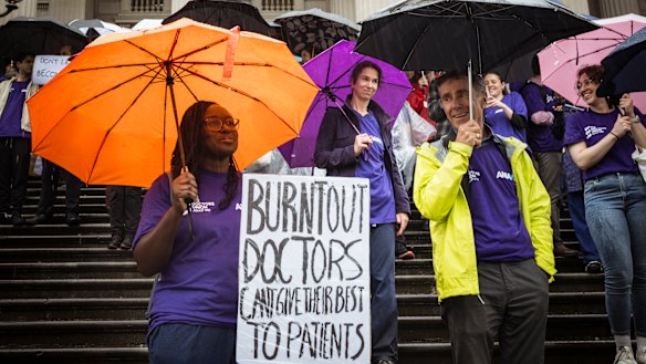 Hundreds of members of the health industry braved torrential rain to protest on the steps of state parliament.