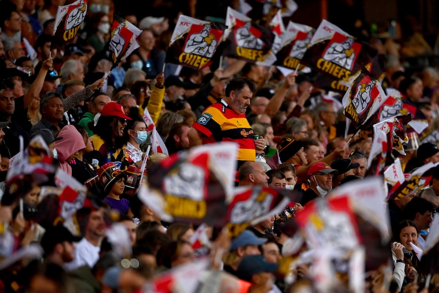 Chiefs spectators watch the Super Rugby final sitting in a grandstand.