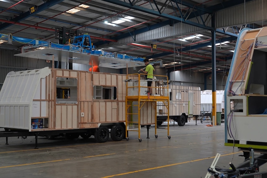 A caravan being manufactured on a factory floor.