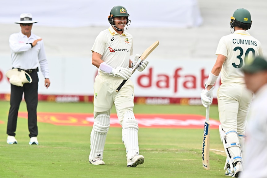 Renshaw smiles with his cricket partner near him.