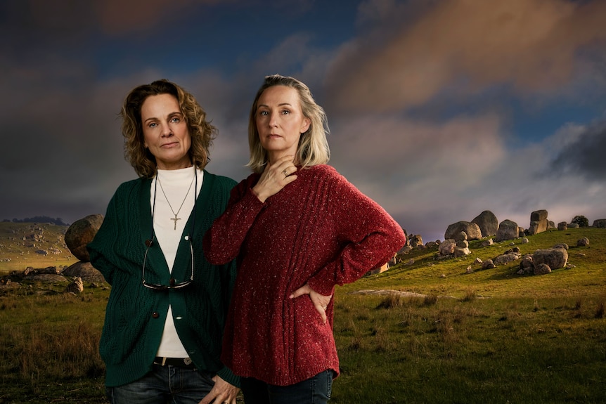 Catherine McClements, 60, looks serious beside Lisa McCune, 55, with a concerned expression, a hand on her neck.