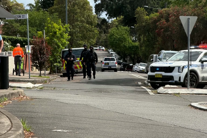 Police officer on street walking next barber