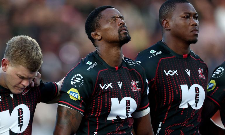 South Africa's Morne Van Den Berg (L) and other Lions players observe a moment of silence in honour of their teammate Hyron Andrews ahead of the European Rugby Champions Cup rugby union match between Stade Rochelais (La Rochelle) and Lions at at the Marcel-Deflandre Stadium in La Rochelle, western France, on October 17, 2026. South African second row Hyron Andrews of Johannesburg-based side the Lions was found dead at a hotel in France on October 16, on the eve of his team's Champions Cup match against La Rochelle, local authorities told AFP. (Photo by ROMAIN PERROCHEAU / AFP)