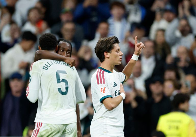 Real Madrid's Turkish midfielder #15 Arda Guler (R) celebrates scoring his team's first goal with teammates during the Spanish league football match between Real Madrid CF and Sevilla FC at the Santiago Bernabeu stadium in Madrid on October 18, 2026. (Photo by Oscar DEL POZO / AFP)