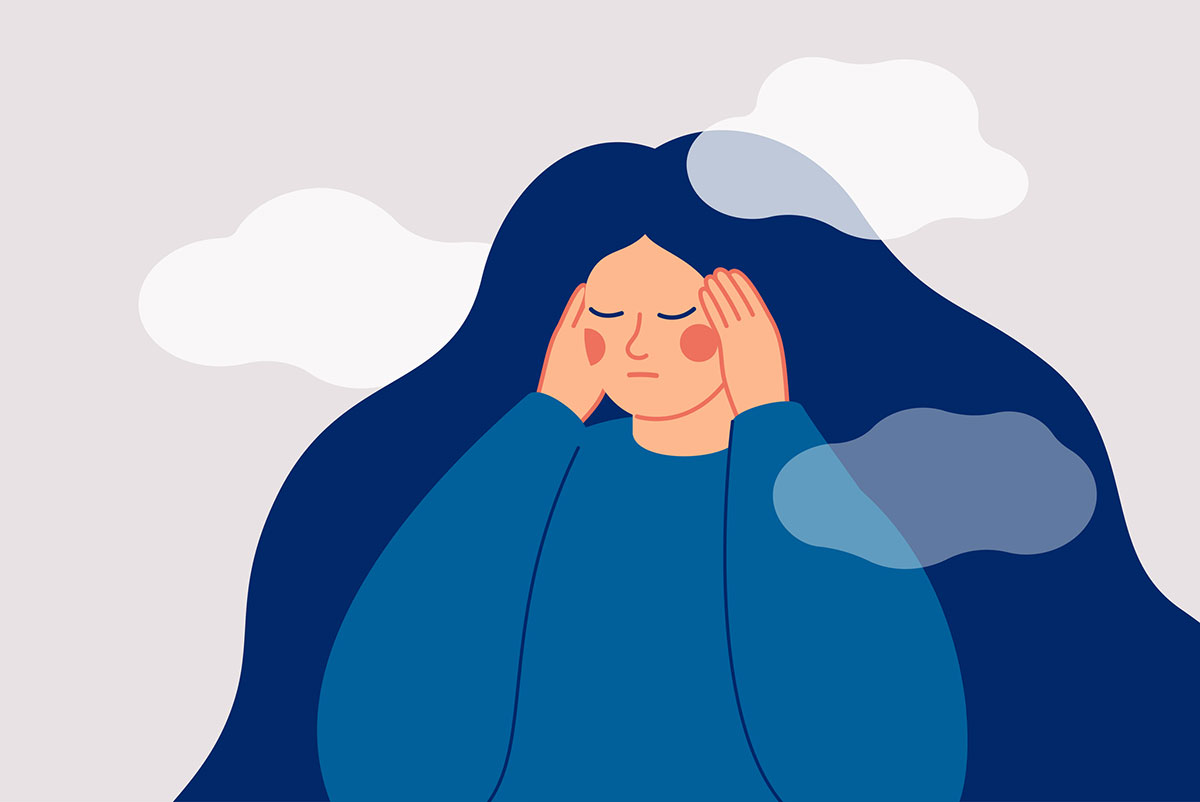 A sad woman touching her temples
