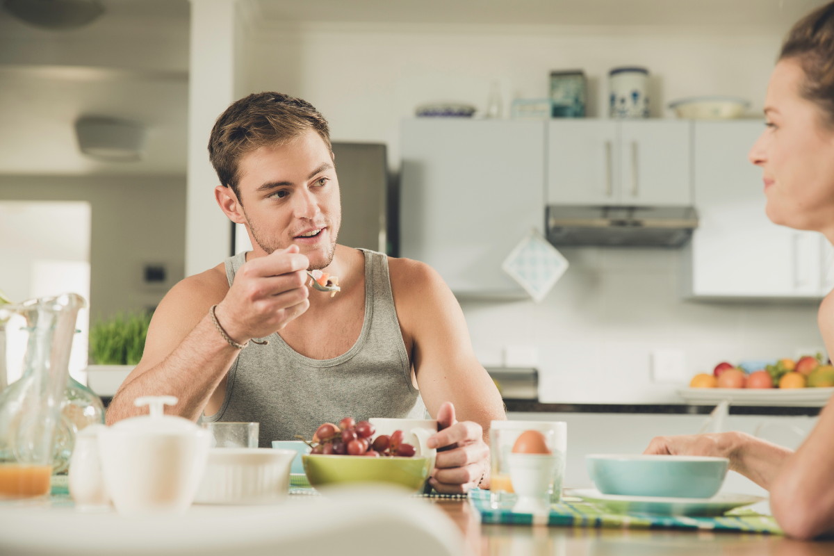 A man and a woman eat breakfast together.