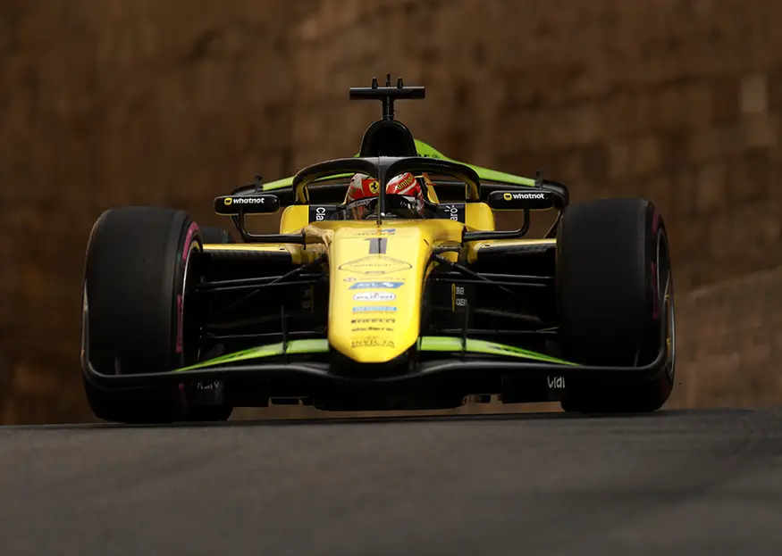Rafael Camara driving the yellow and black #1 Invicta Racing Formula 2 car over a crest during the 2026 Azerbaijan Grand Prix weekend.