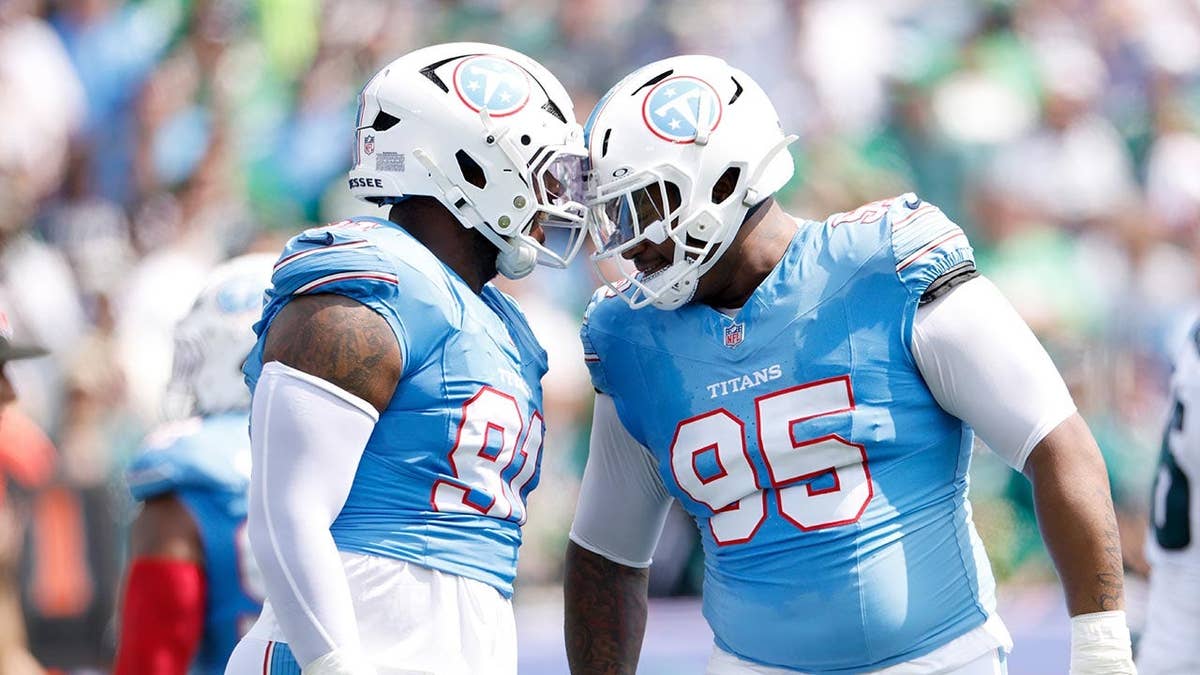 Tennessee Titans teammates celebrating after a tackle