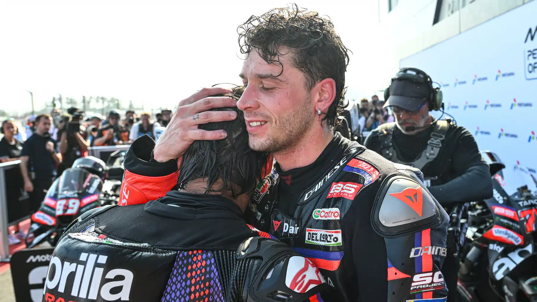 Bezzecchi and Martin congratulate each other, both destroyed by 40 minutes wrestling burning hot motorcycles around Mandalika