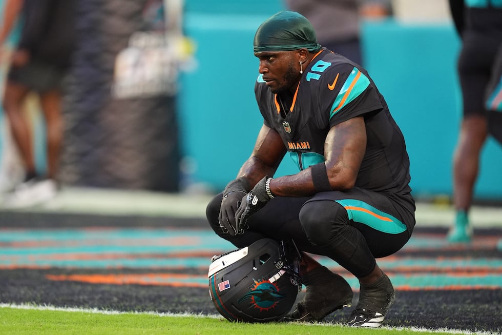 FILE - Miami Dolphins wide receiver Tyreek Hill sits in the end zone before an NFL football...