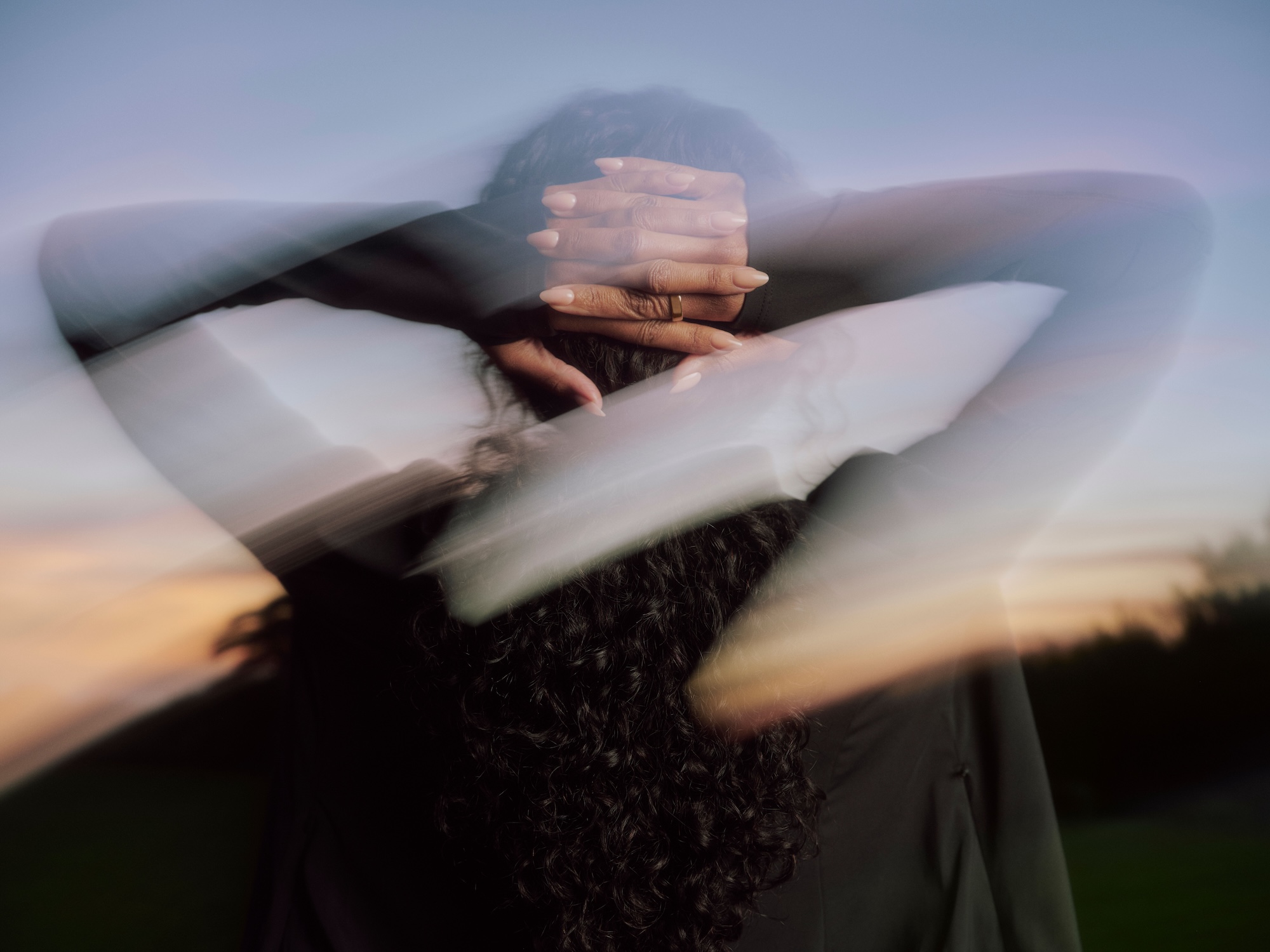 Woman wearing Oura Ring 5 with hands on her head after a workout