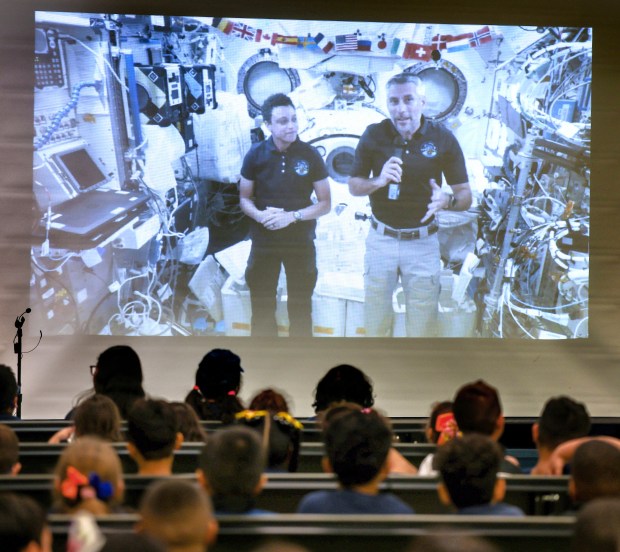 Students in Sally Ride Elementary School's Aviation and Aerospace Magnet Program listen while NASA astronauts Jessica Watkins and Luke Delaney talk to them live from the International Space Station, Friday, October 16, 2026. 26 students posed questions about living in space as a part of NASA's In-flight STEM Downlink program. (Joe Burbank/Orlando Sentinel)
