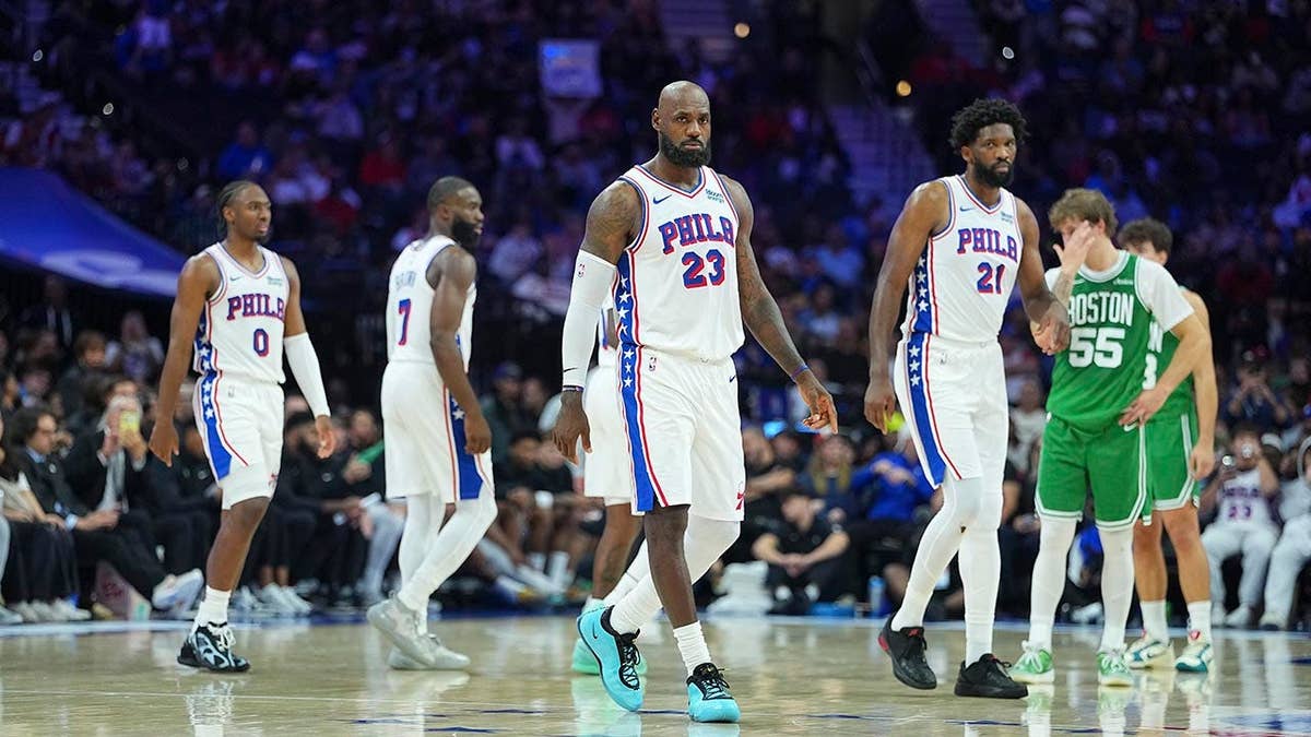 LeBron James, Joel Embiid, Jaylen Brown and Tyrese Maxey look on during a preseason game
