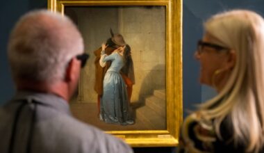Visually impaired and blind visitors at Pinacoteca di Brera in front of Francesco Hayez's artwork "The Kiss" with the AI glasses developed by Meta and EssilorLuxottica