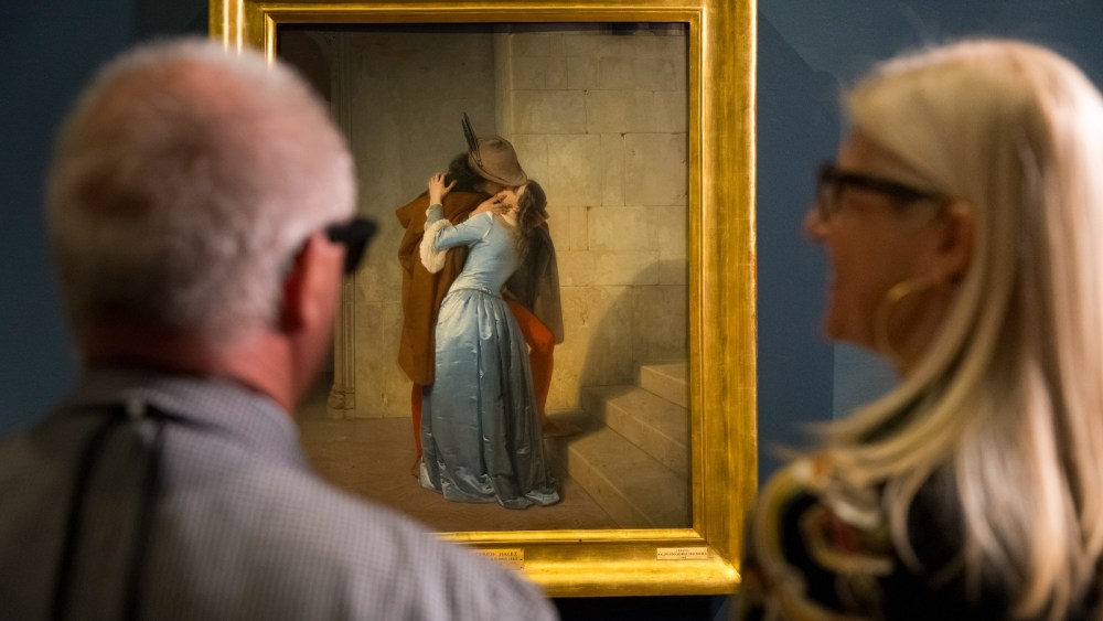 Visually impaired and blind visitors at Pinacoteca di Brera in front of Francesco Hayez's artwork "The Kiss" with the AI glasses developed by Meta and EssilorLuxottica
