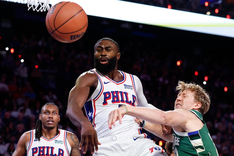 Jaylen Brown fights for a loose ball with Milwaukee Bucks guard Kasparas Jakucionis in the third quarter on Saturday,