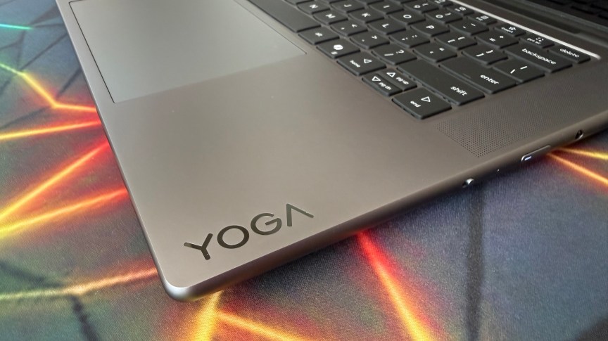 Yoga branding on the inside of the Yoga Pro 7i's clamshell design. The keyboard and trackpad are also in sight.