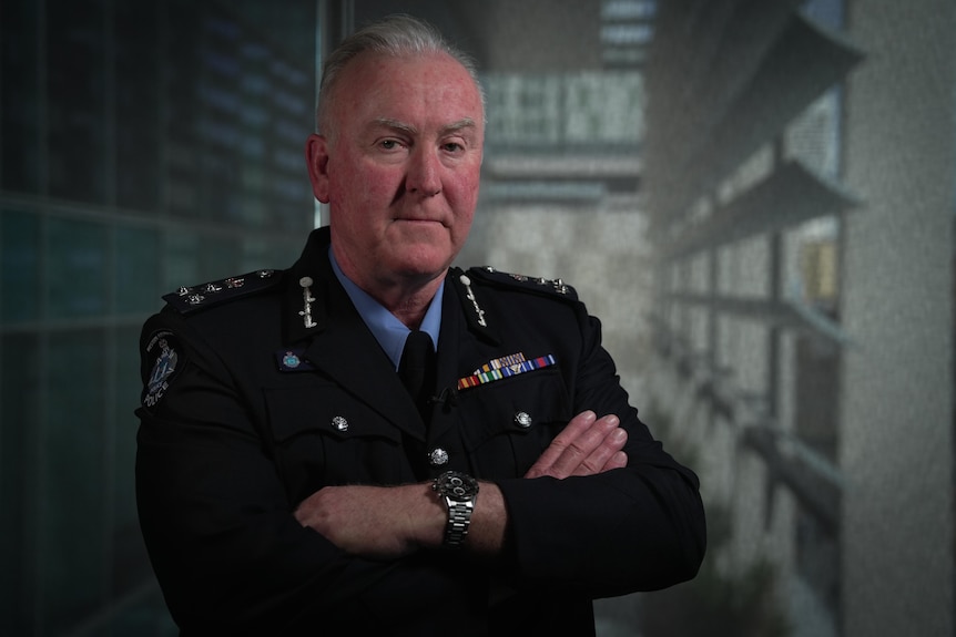 A Western Australian police officer folds his arms.