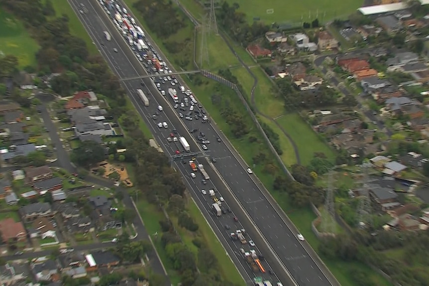 An aerial shot of a long line of traffic behind an incident on a freeway.
