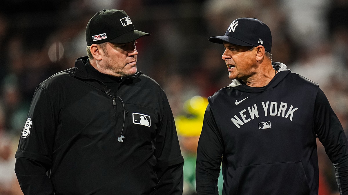 New York Yankees manager Aaron Boone (17) has words with the officials as they take on the Boston Red Sox in the tenth inning at Fenway Park on June 13, 2025.